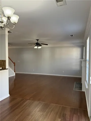 a view of a room with wooden floor and staircase