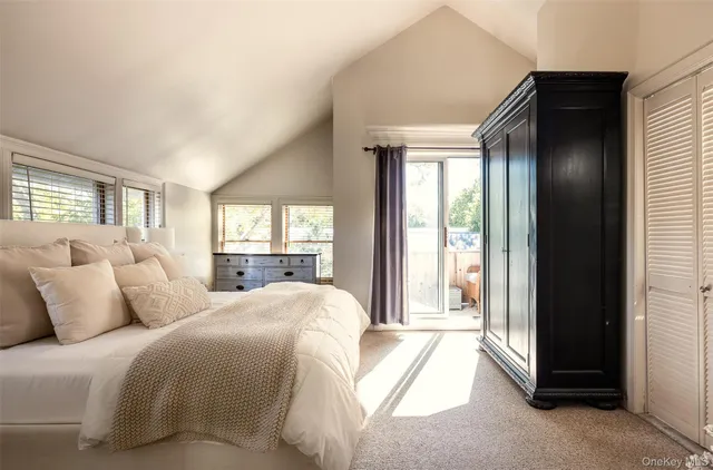 a spacious bedroom with a bed and a large window