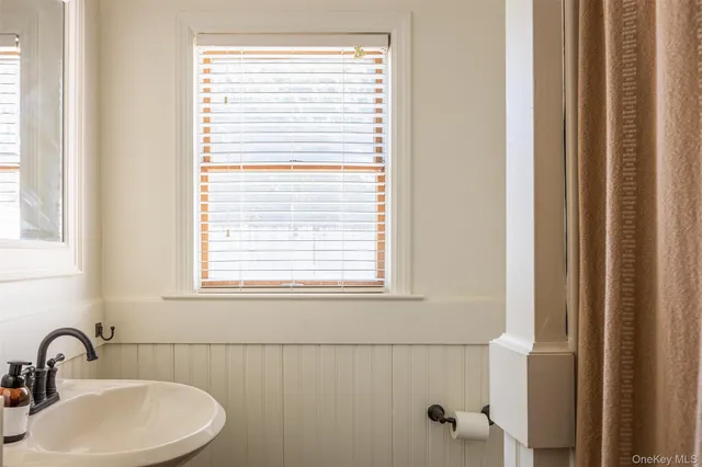 a bathroom with a sink and a window