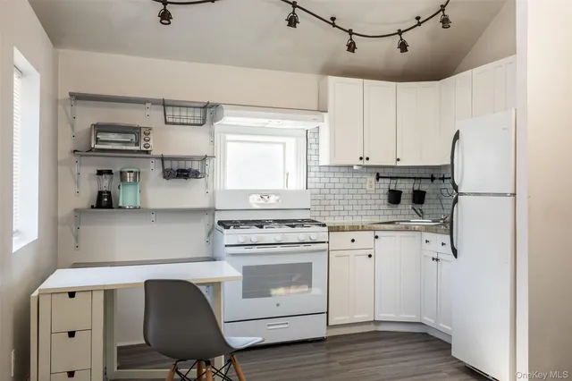 a kitchen with cabinets a sink and appliances