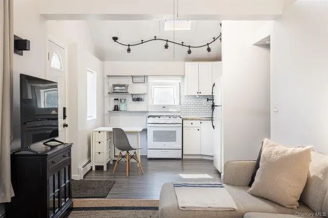a kitchen with cabinets and chairs