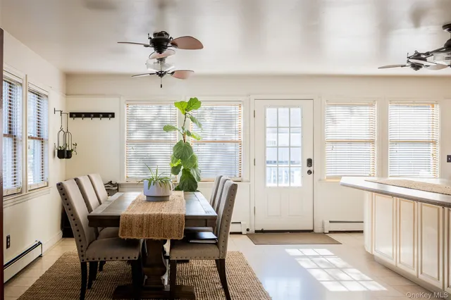 a view of a dining room with furniture and a window