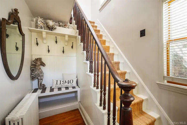 a view of entryway and hall with wooden floor