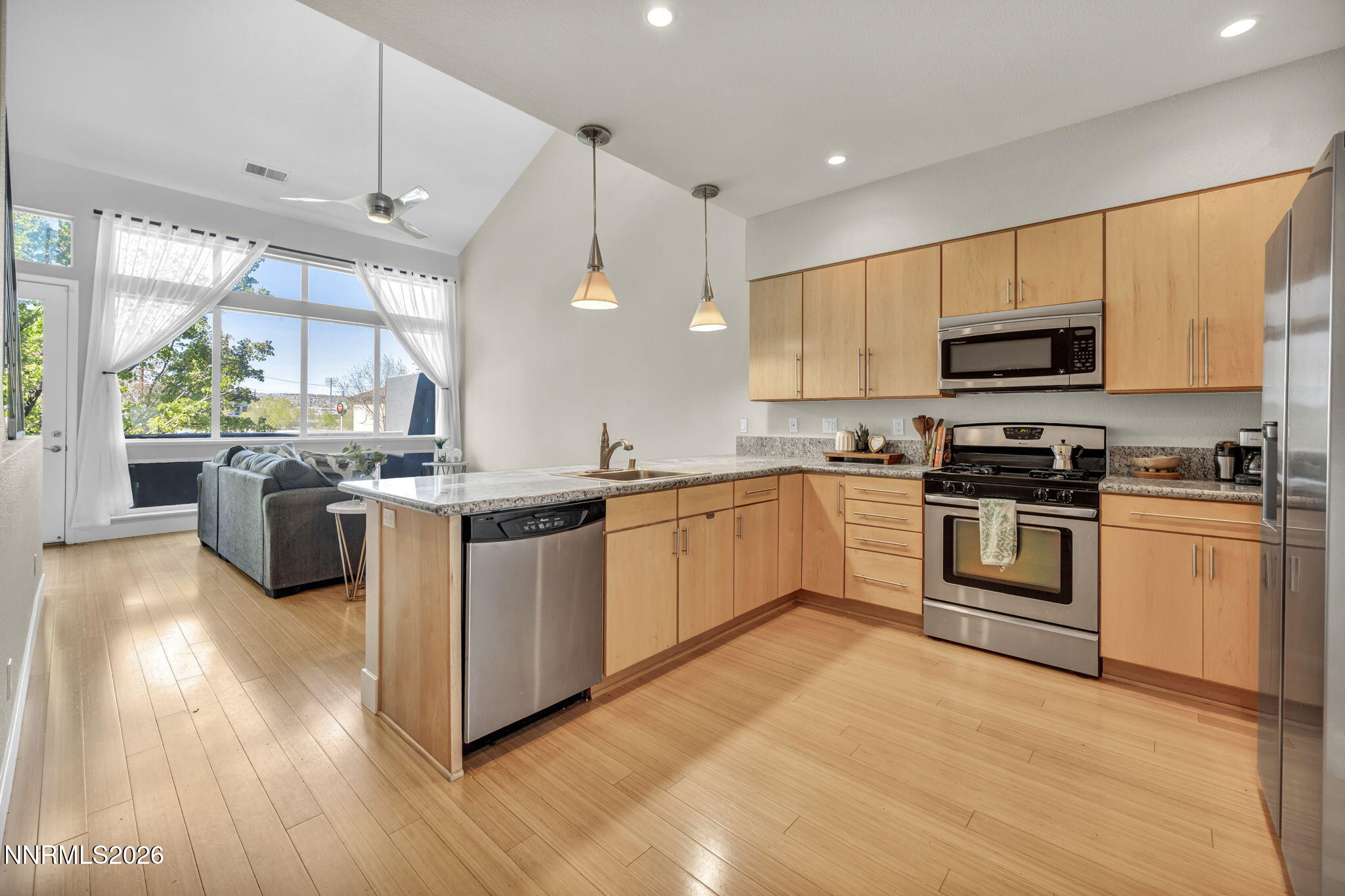 326 State Street Reno, NV 89501 - Photo 21 of 49 a kitchen with stainless steel appliances granite countertop a stove top oven a sink dishwasher and a refrigerator with wooden floor