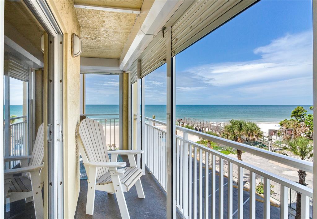 17450 Gulf Boulevard, Unit 206 Redington Shores, FL 33708 - Photo 18 of 52 a view of a balcony with chair and floor to ceiling window