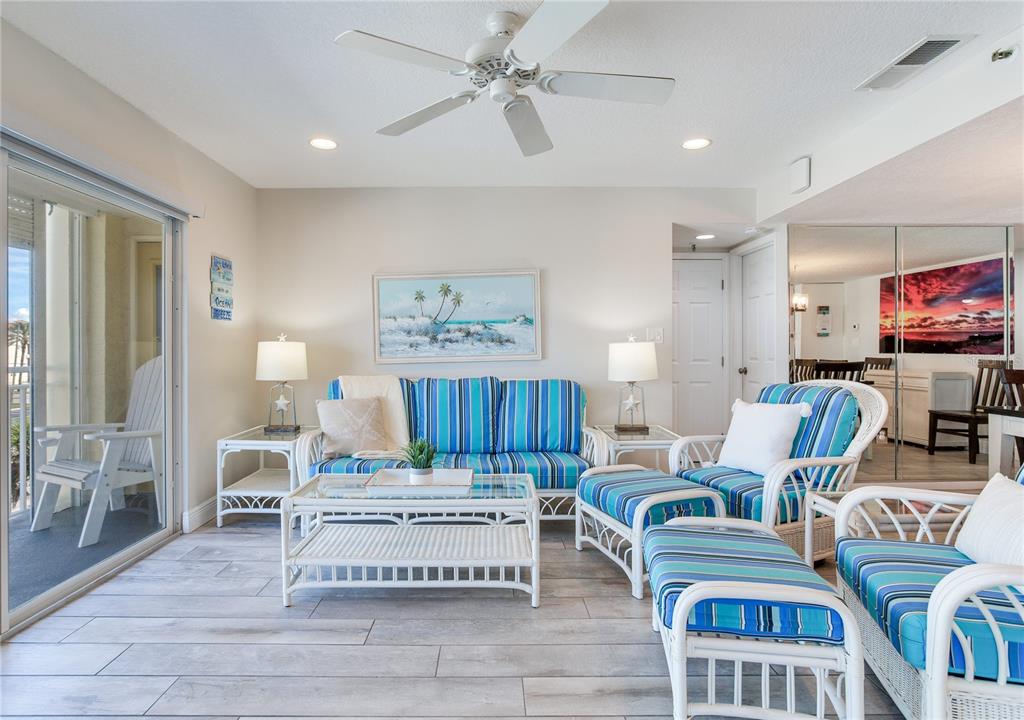 17450 Gulf Boulevard, Unit 206 Redington Shores, FL 33708 - Photo 21 of 52 a living room with furniture and a flat screen tv