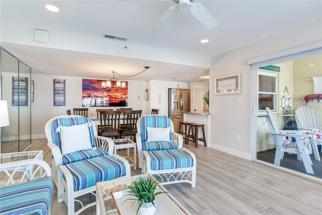 17450 Gulf Boulevard, Unit 206 Redington Shores, FL 33708 - Photo 22 of 52 a living room with furniture and wooden floor