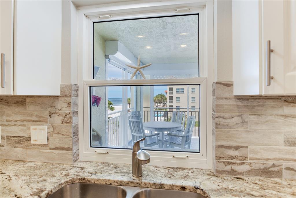 17450 Gulf Boulevard, Unit 206 Redington Shores, FL 33708 - Photo 29 of 52 a view of a hallway with wooden floor and a mirror