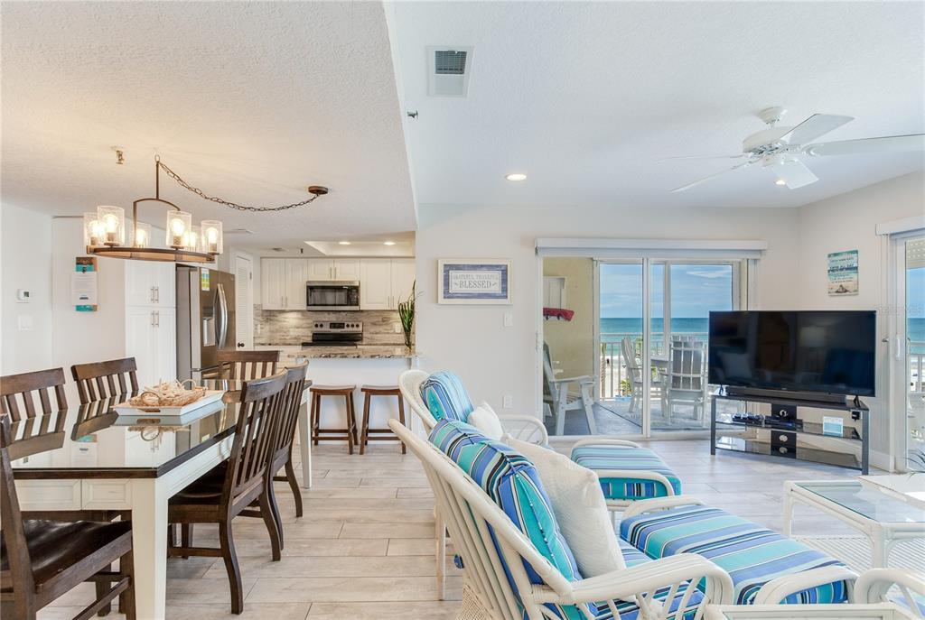 17450 Gulf Boulevard, Unit 206 Redington Shores, FL 33708 - Photo 31 of 52 a living room with furniture and a flat screen tv