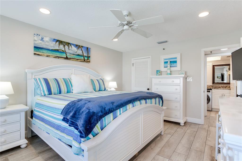 17450 Gulf Boulevard, Unit 206 Redington Shores, FL 33708 - Photo 33 of 52 a bedroom with a bed and a chandelier