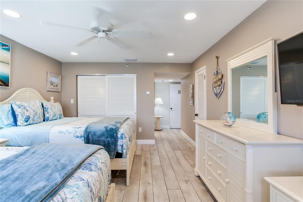 17450 Gulf Boulevard, Unit 206 Redington Shores, FL 33708 - Photo 41 of 52 a spacious bedroom with a bed and a dresser