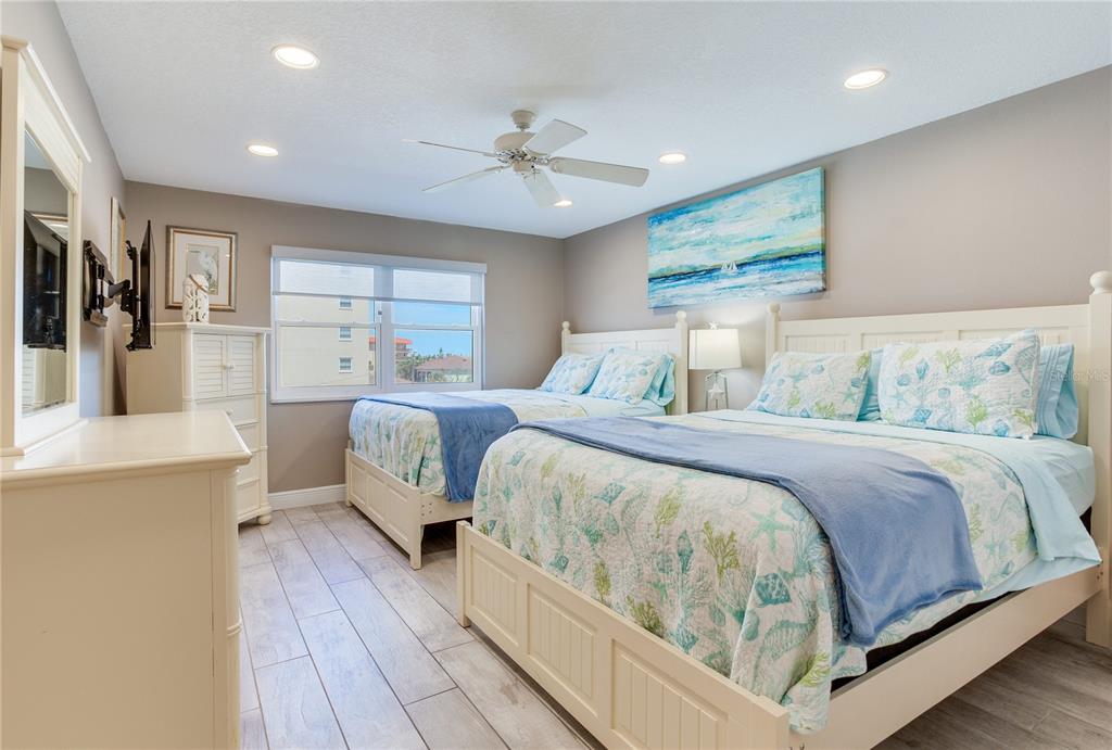17450 Gulf Boulevard, Unit 206 Redington Shores, FL 33708 - Photo 44 of 52 a bedroom with a bed and a chandelier