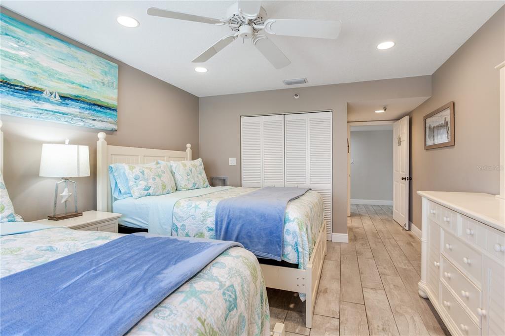 17450 Gulf Boulevard, Unit 206 Redington Shores, FL 33708 - Photo 45 of 52 a bedroom with bed and a chandelier