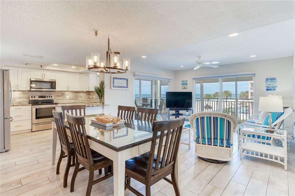 17450 Gulf Boulevard, Unit 206 Redington Shores, FL 33708 - Photo 8 of 52 a view of a dining room with furniture and wooden floor