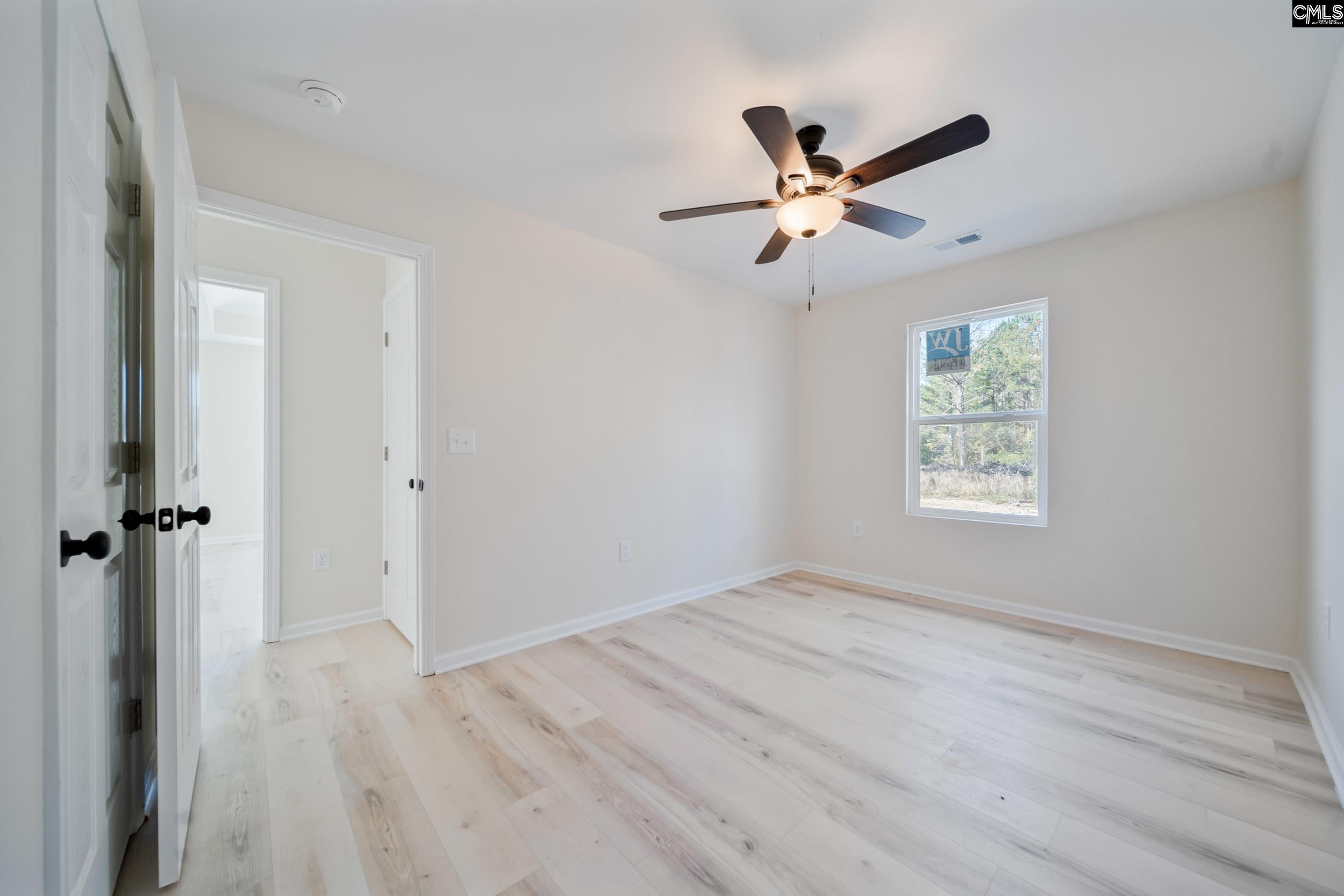 116 Sunny Acres Road Eastover, SC 29044 - Photo 18 of 40 a view of a ceiling fan and wooden floor