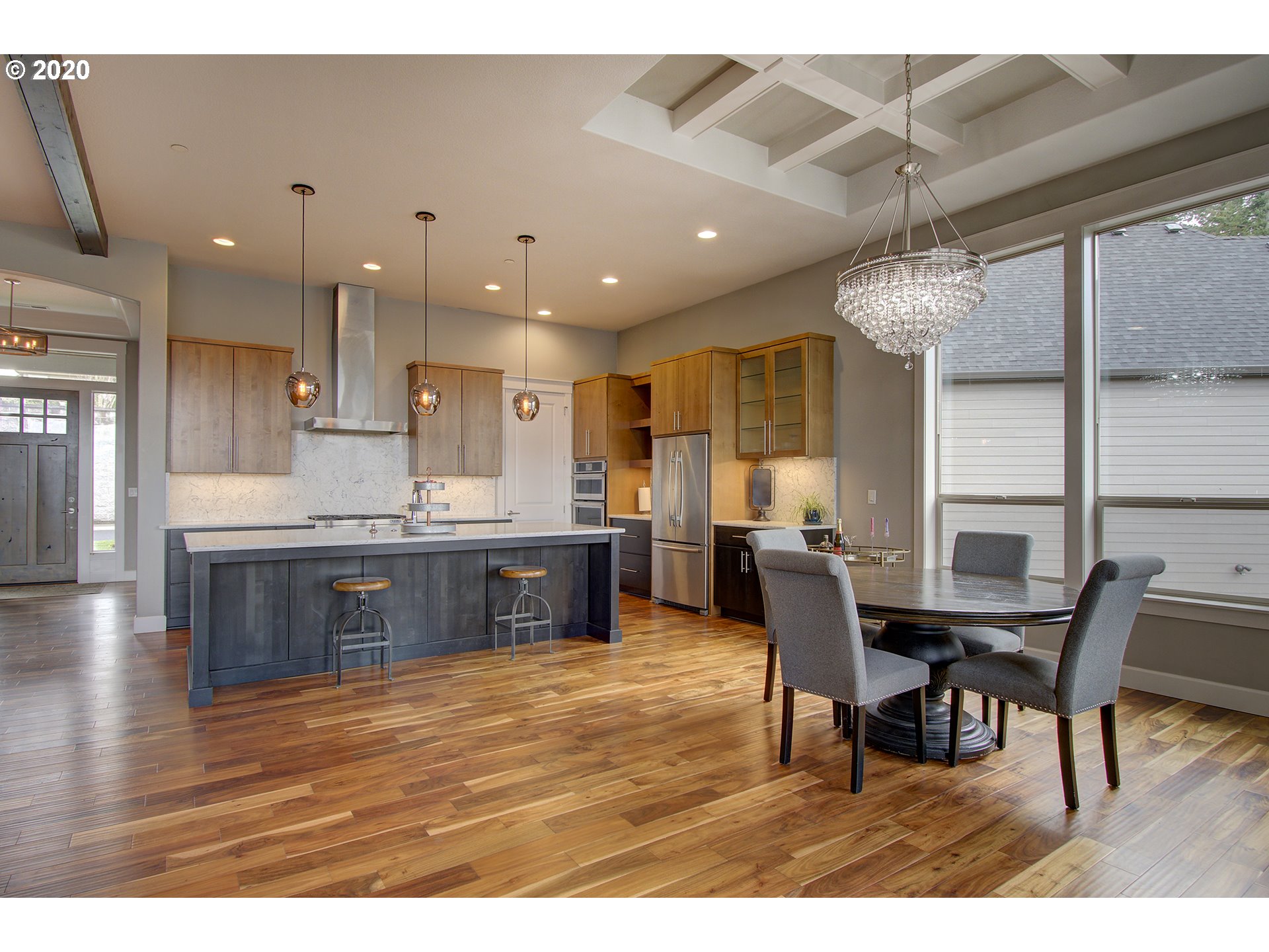 3221 Northwest Lake Place Camas, WA 98607 - Photo 6 of 32 a kitchen with stainless steel appliances kitchen island granite countertop a table and chairs in it