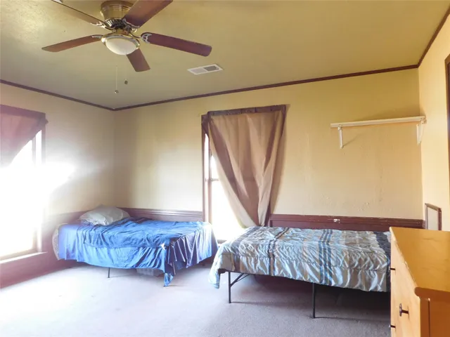a bedroom with a bed and a chandelier