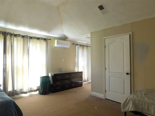 a living room with a bed and a window