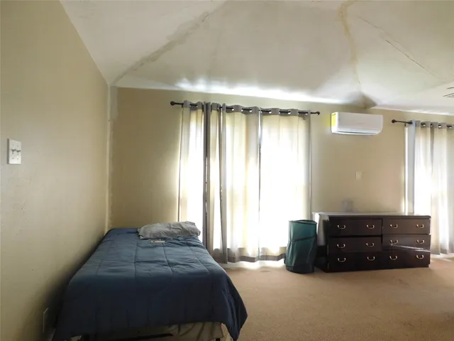 a bedroom with a bed and window