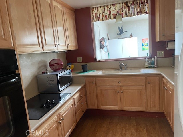 13360 Del Monte Drive, Unit 2B Seal Beach, CA 90740 - Photo 11 of 28 a kitchen with stainless steel appliances a stove a sink a refrigerator and cabinets