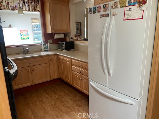 13360 Del Monte Drive, Unit 2B Seal Beach, CA 90740 - Photo 13 of 28 a kitchen with stainless steel appliances a refrigerator and a sink