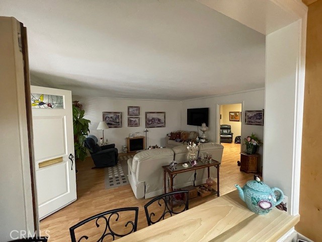 13360 Del Monte Drive, Unit 2B Seal Beach, CA 90740 - Photo 15 of 28 a living room with furniture flat screen tv and a refrigerator