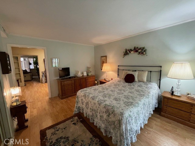 13360 Del Monte Drive, Unit 2B Seal Beach, CA 90740 - Photo 19 of 28 a bedroom with bed and wooden floor