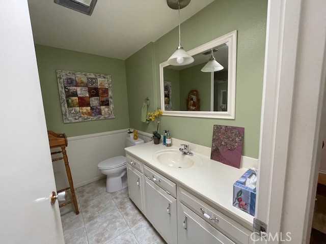 13360 Del Monte Drive, Unit 2B Seal Beach, CA 90740 - Photo 23 of 28 a bathroom with a sink a toilet and mirror