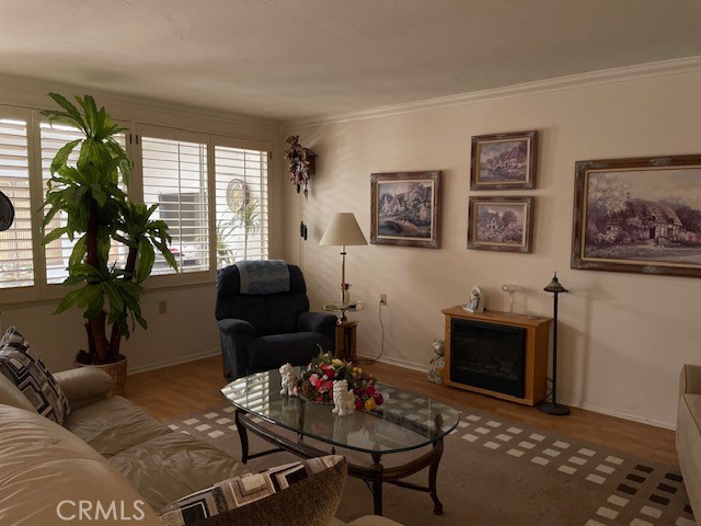 13360 Del Monte Drive, Unit 2B Seal Beach, CA 90740 - Photo 25 of 28 a living room with furniture a flat screen tv and a fireplace