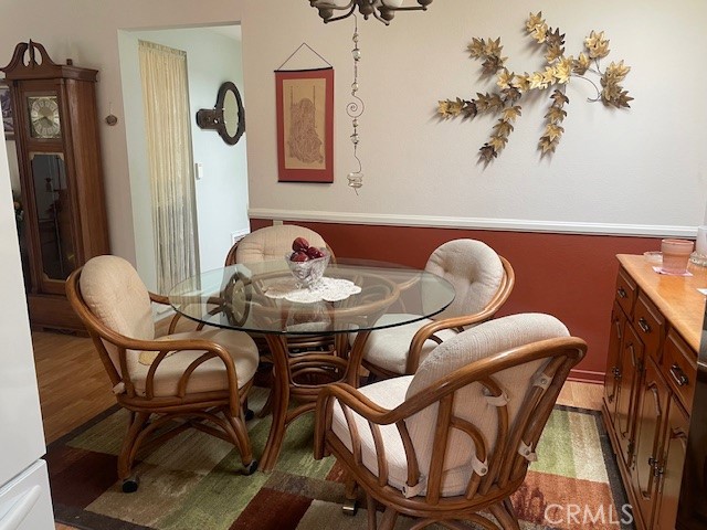 13360 Del Monte Drive, Unit 2B Seal Beach, CA 90740 - Photo 26 of 28 a dining room with furniture and wooden floor