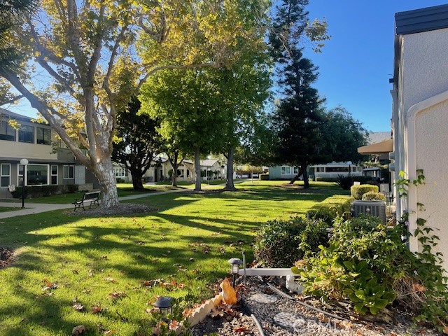 13360 Del Monte Drive, Unit 2B Seal Beach, CA 90740 - Photo 3 of 28 a view of a swimming pool with lawn chairs and a big yard