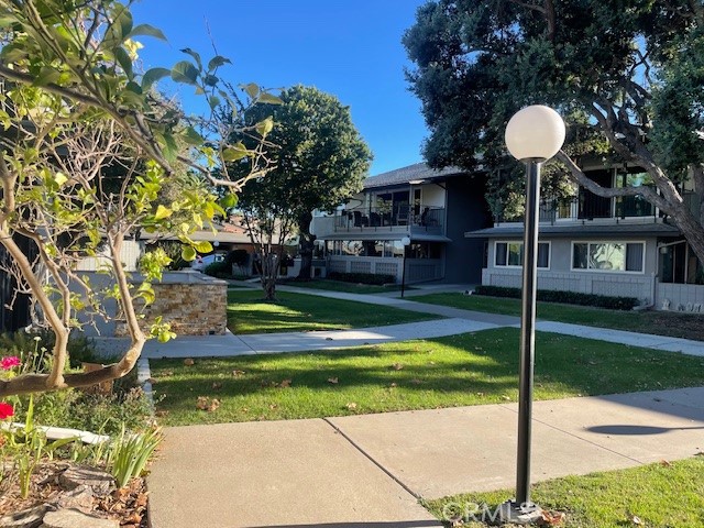 13360 Del Monte Drive, Unit 2B Seal Beach, CA 90740 - Photo 4 of 28 a front view of a house with a yard and green space