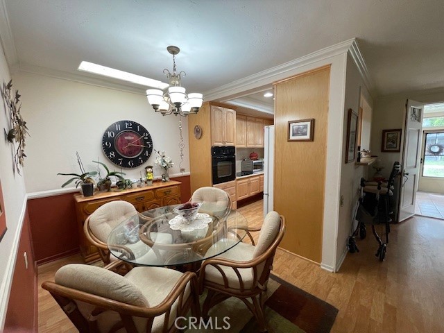 13360 Del Monte Drive, Unit 2B Seal Beach, CA 90740 - Photo 9 of 28 a dining room with furniture and chandelier