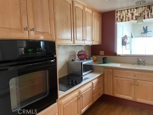 13360 Del Monte Drive, Unit 2B Seal Beach, CA 90740 - Photo 10 of 28 a kitchen with stainless steel appliances granite countertop a stove a sink and a microwave