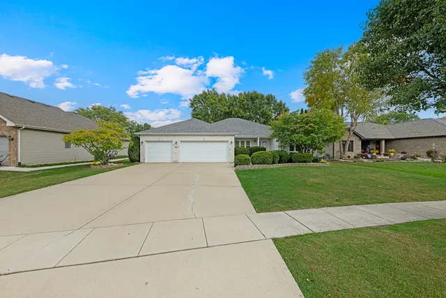 a front view of a house with a yard and garage