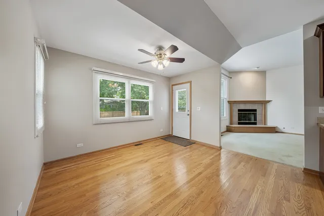 a view of kitchen with kitchen island stainless steel appliances sink cabinets and window