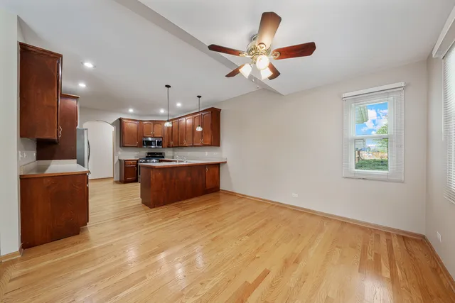 a kitchen with stainless steel appliances granite countertop a sink refrigerator and cabinets