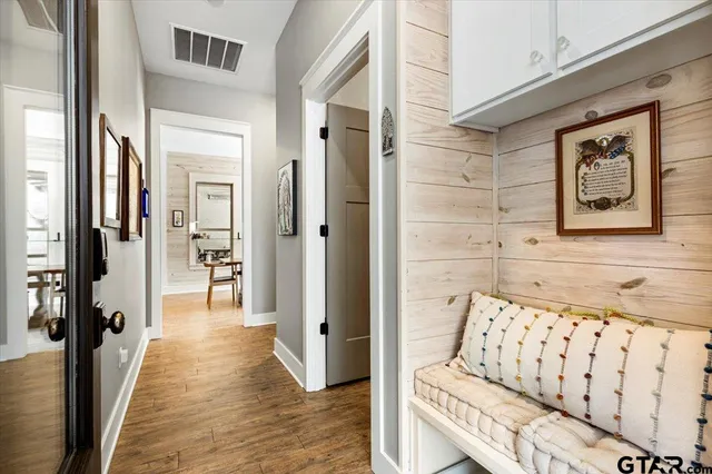 a hallway with wooden floor and furniture