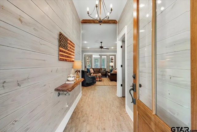 a very nice looking room with a large window and chandelier