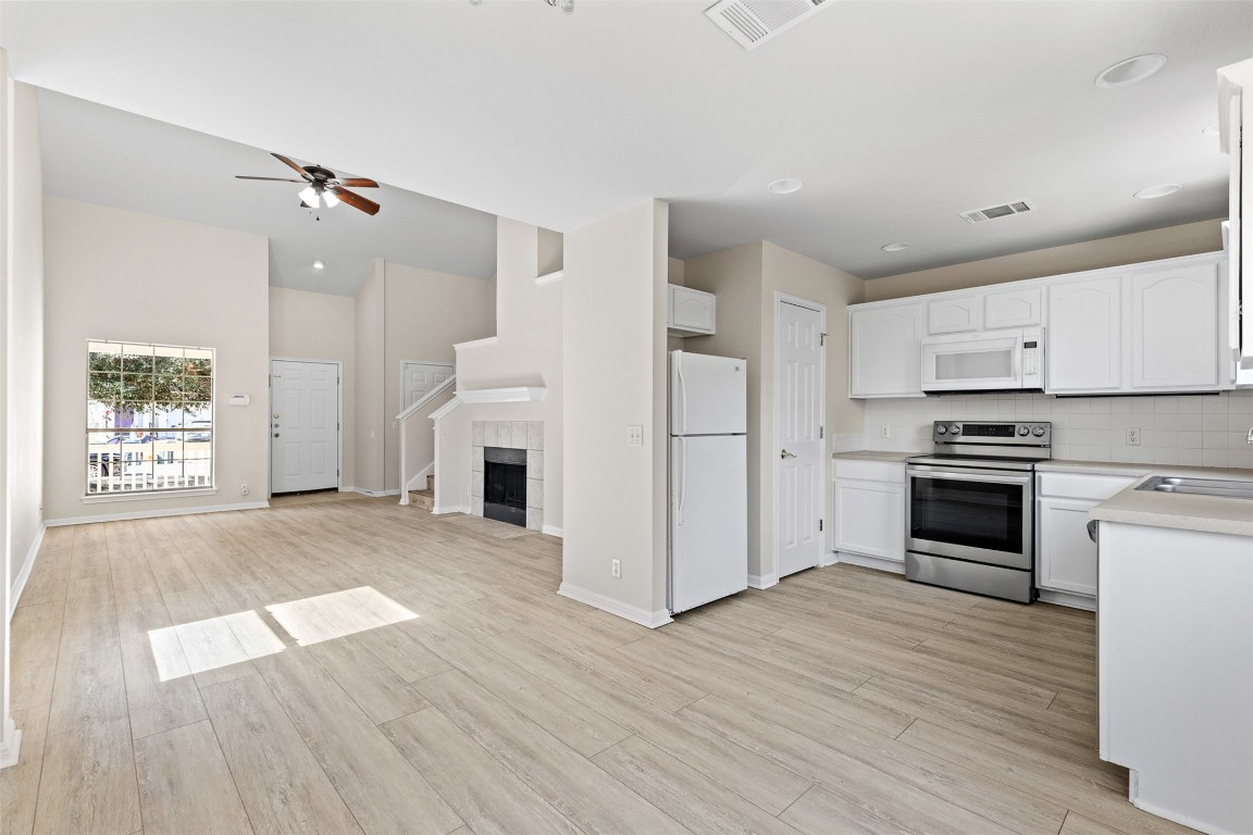 102 Orange Tree Lane Georgetown, TX 78626 - Photo 31 of 31 a view of a kitchen with a white cabinet and a stove top oven