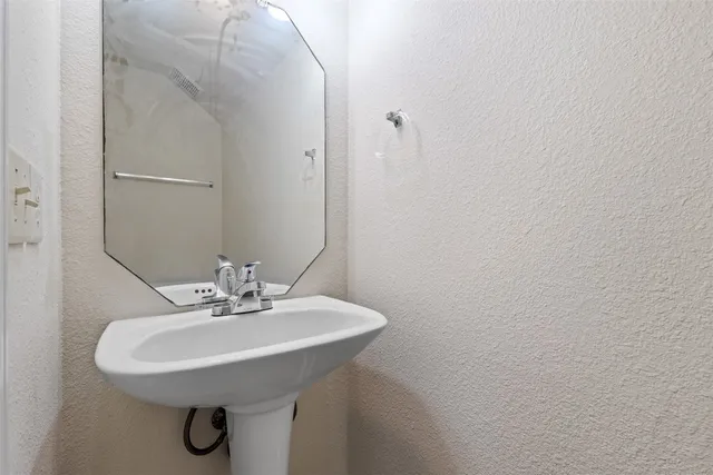 a kitchen with stainless steel appliances granite countertop a sink and cabinets with wooden floors