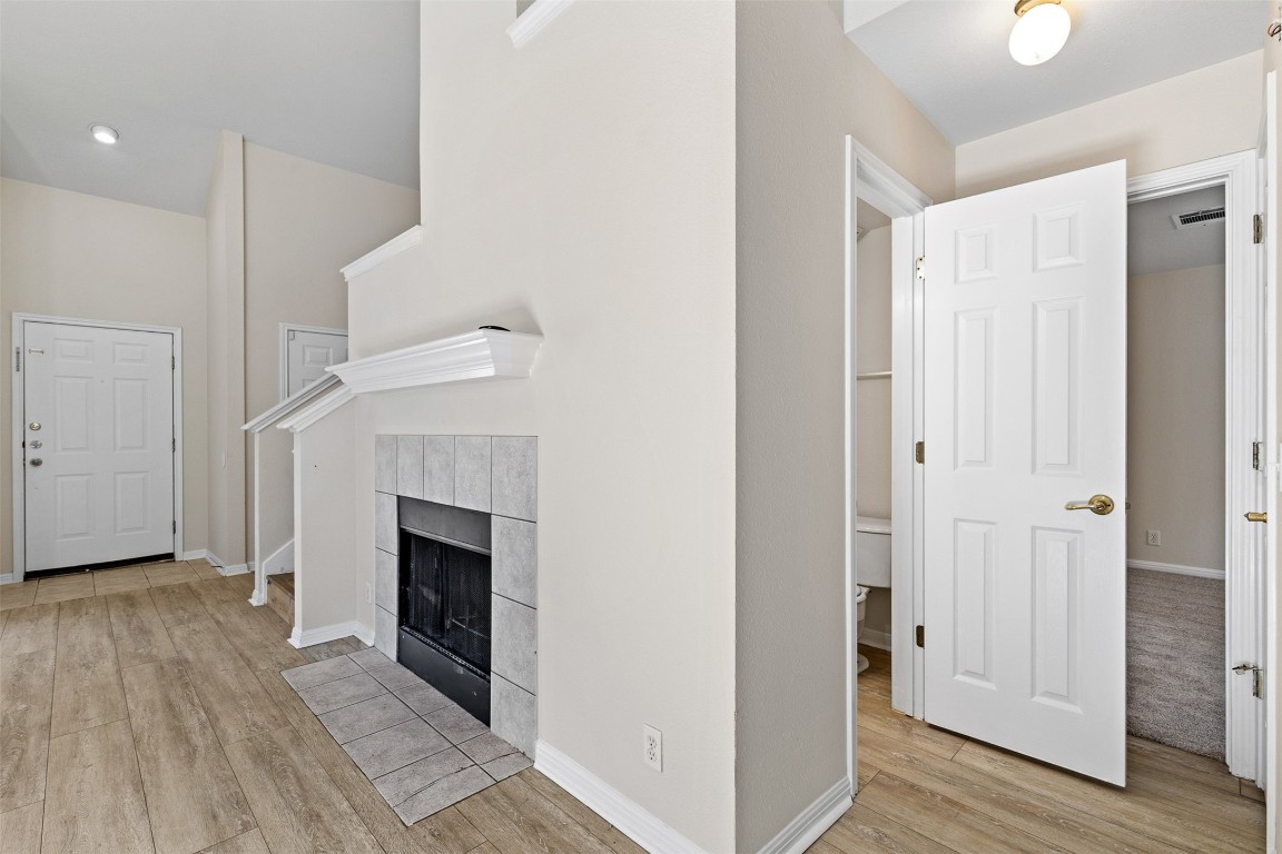 102 Orange Tree Lane Georgetown, TX 78626 - Photo 13 of 31 a view of a livingroom with wooden floor and a fireplace