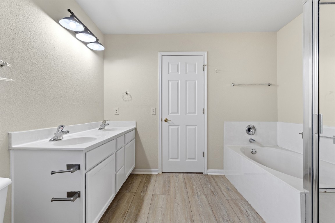 102 Orange Tree Lane Georgetown, TX 78626 - Photo 18 of 31 a spacious bathroom with a tub sink and mirror