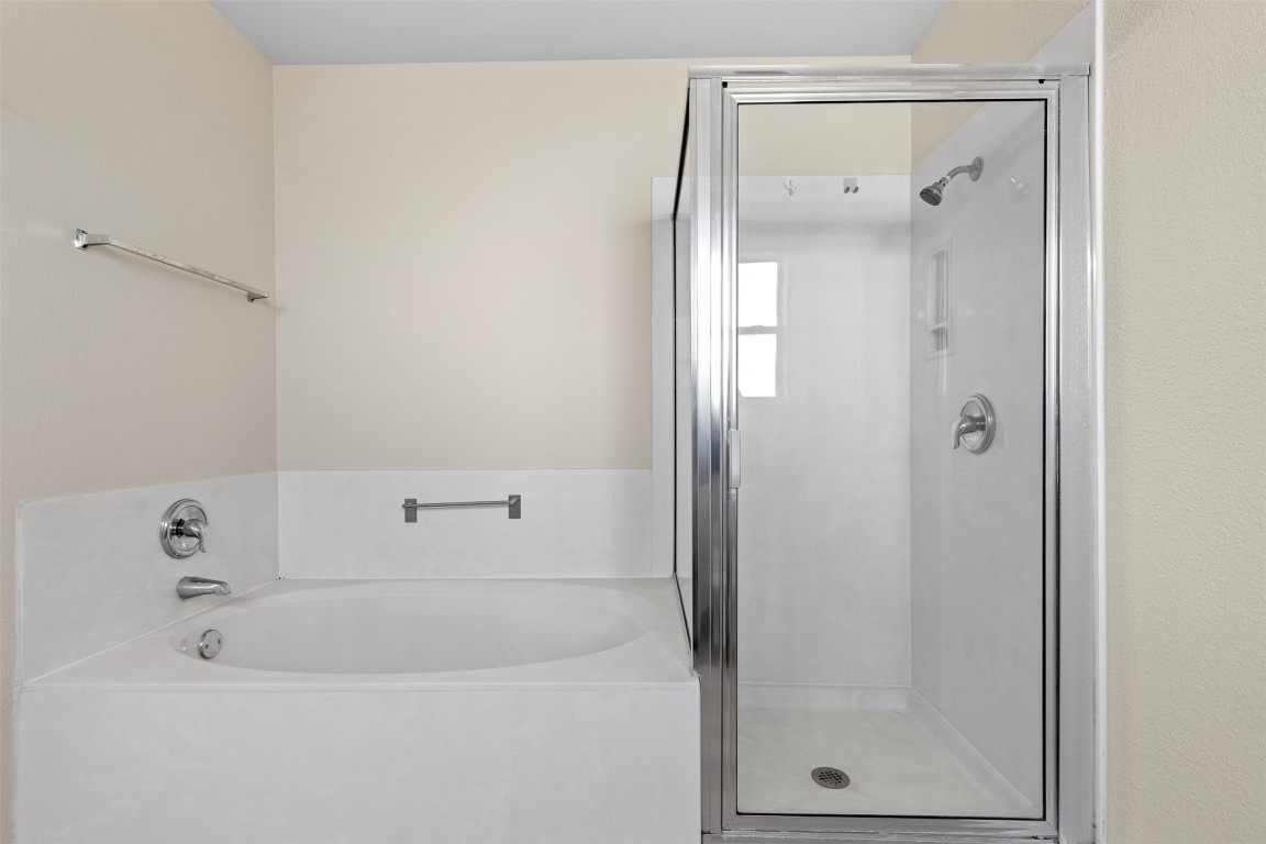102 Orange Tree Lane Georgetown, TX 78626 - Photo 19 of 31 a bathroom with a bathtub and a shower