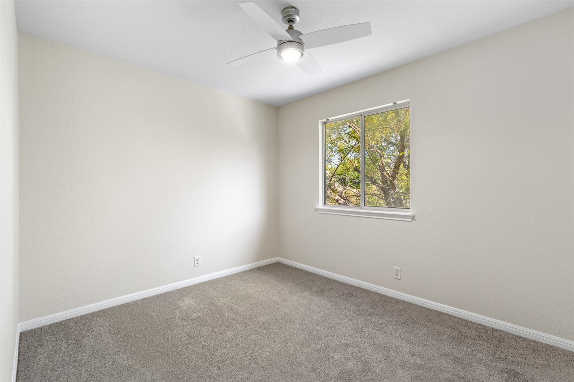 102 Orange Tree Lane Georgetown, TX 78626 - Photo 26 of 31 an empty room with a window and ceiling fan