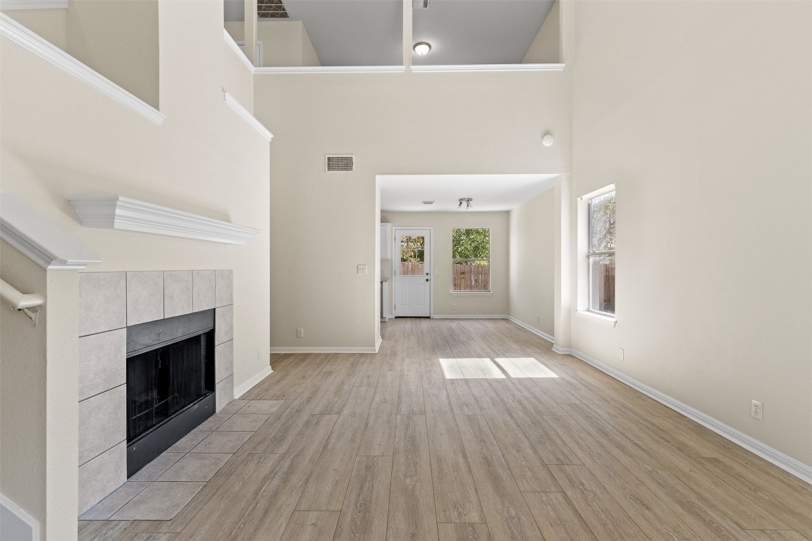 102 Orange Tree Lane Georgetown, TX 78626 - Photo 7 of 31 a view of empty room with wooden floor and fireplace