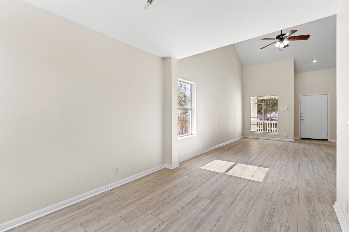102 Orange Tree Lane Georgetown, TX 78626 - Photo 9 of 31 wooden floor in an empty room with a window