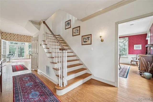 a view of an entryway with wooden floor and door
