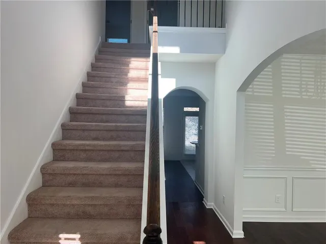 a view of entryway and hall with wooden floor