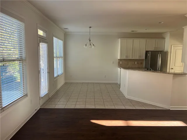 a view of a kitchen with wooden floor and a sink